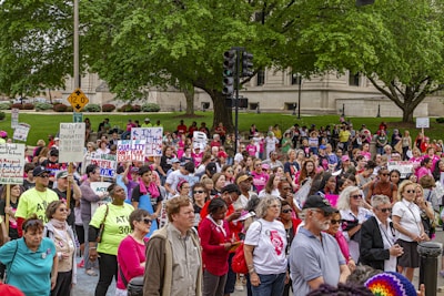 Women advocating for employment rights, holding signs and speaking passionately at a community event.