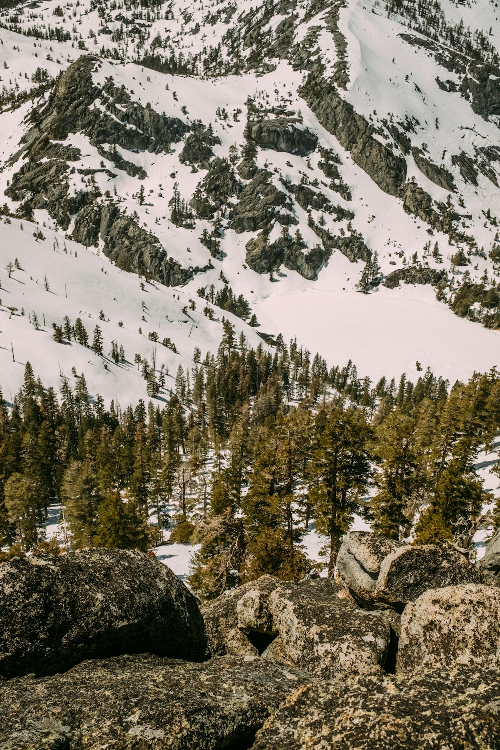 a man standing on top of a snow covered mountain