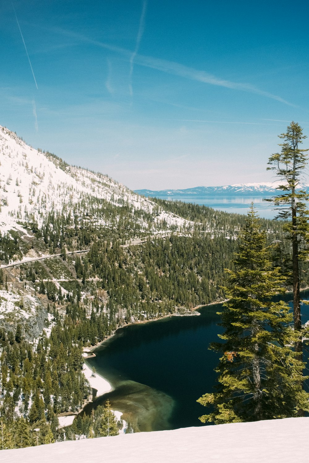 a snow covered mountain with a lake in the middle