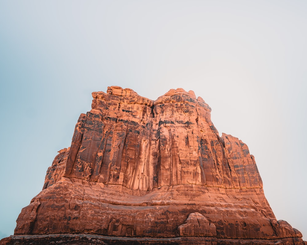 a large rock formation with a sky background