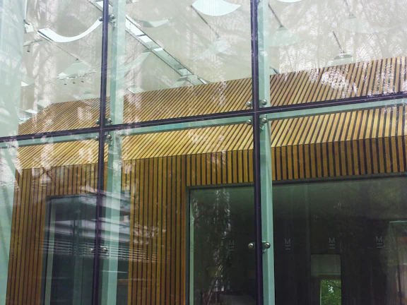 Before and after shots of a home renovation featuring glass and aluminum work.