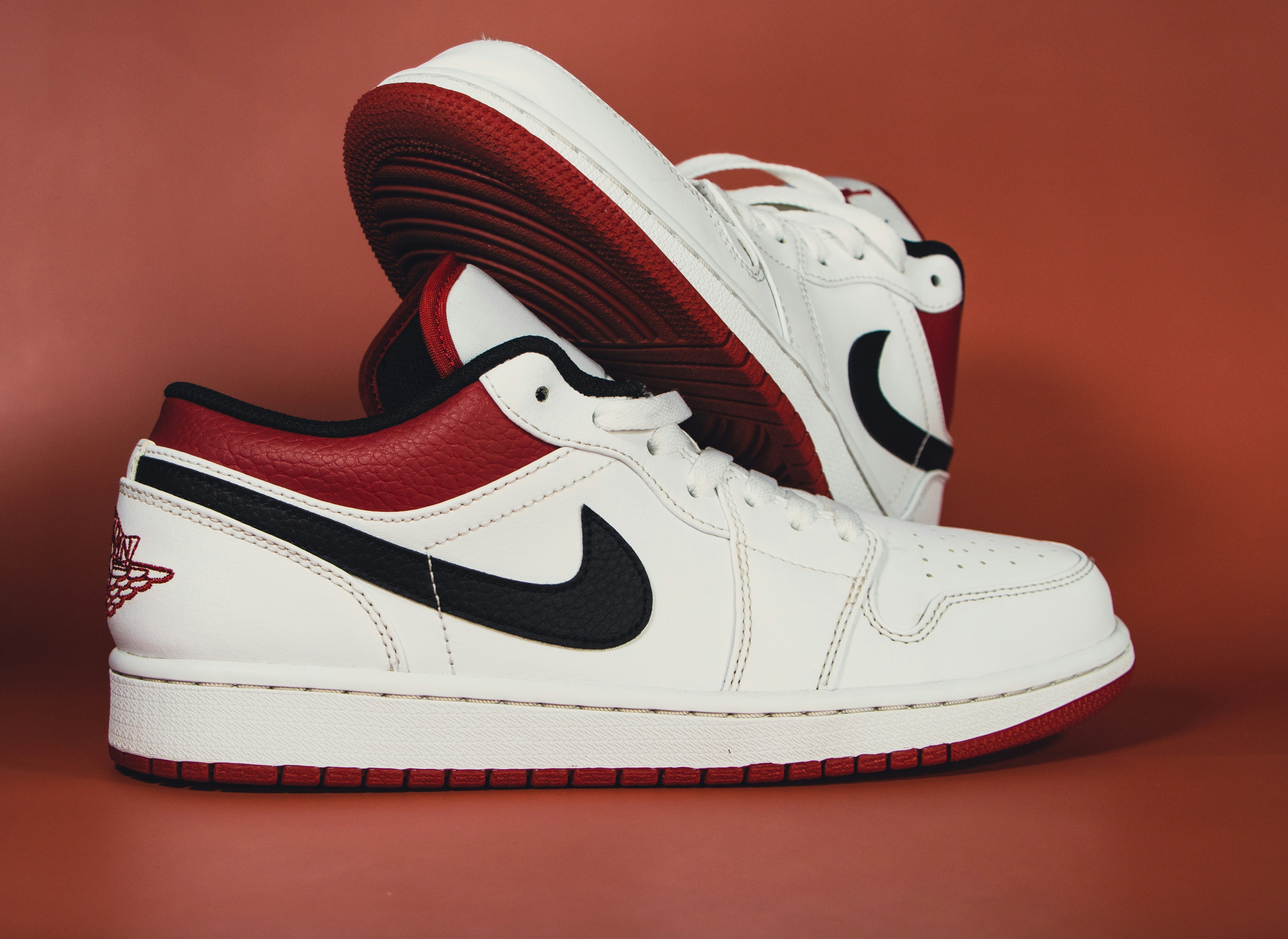 Stylish red and white casual sneakers on clean white background