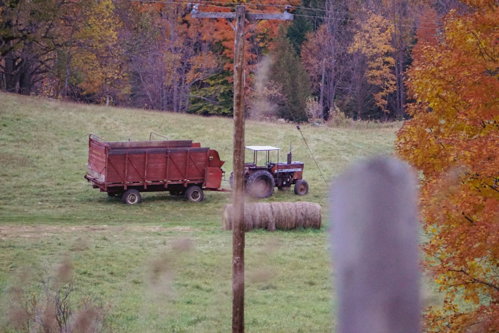 a tractor pulling a bale of hay in a field