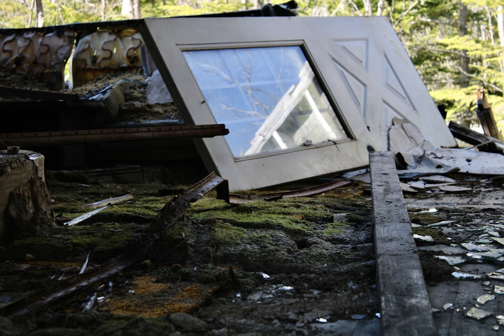 a broken window sitting on top of a pile of rubble