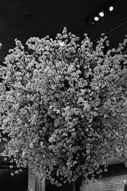 A vibrant arrangement of colorful flowers designed for a large celebration, elegantly displayed in a bright, airy setting.