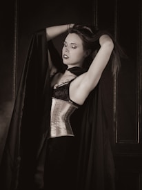 a woman in a corset is posing for a picture