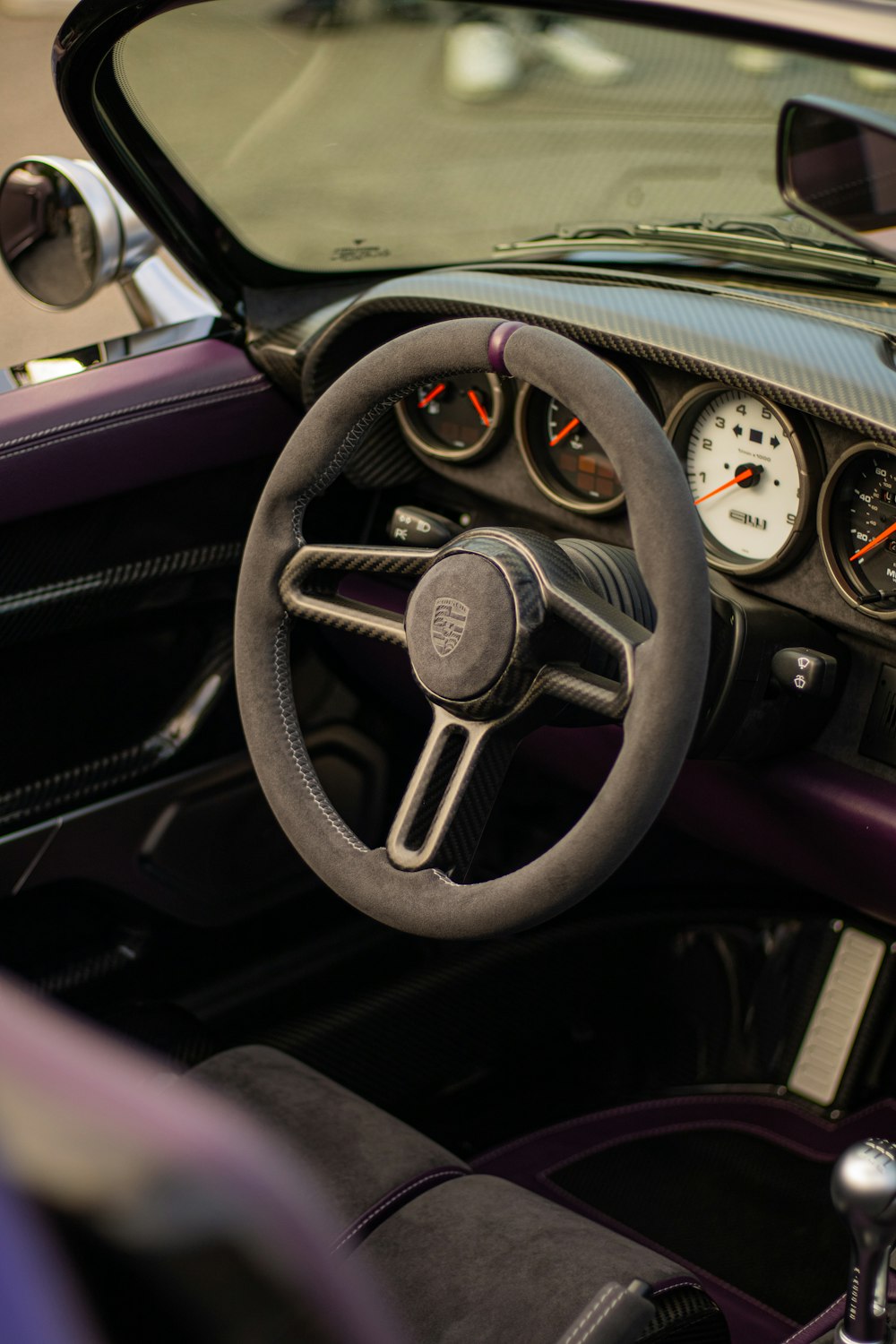 the interior of a car with a steering wheel and gauges