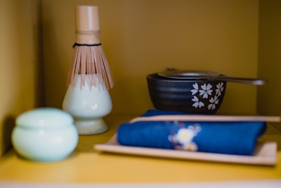 Close-up of a handcrafted bamboo tea whisk resting on a traditional Japanese tea cloth