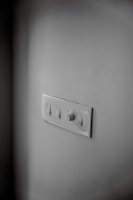 Modern touch sensor switch panel illuminated softly in a dim room.