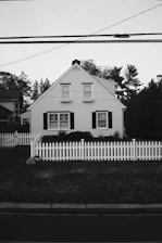 a white house with a white picket fence