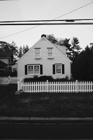 a white house with a white picket fence