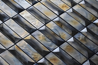 Close-up of elegant bronze and gold-toned ceramic tiles arranged in a modern pattern.