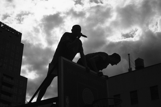 A dynamic cityscape backdrop with a basketball influencer and a boxing influencer each showcasing stylish sportswear and gear.