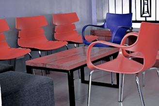 Upholstered visitor chairs arranged neatly around a glass meeting table, showcasing clean lines and comfortable design.