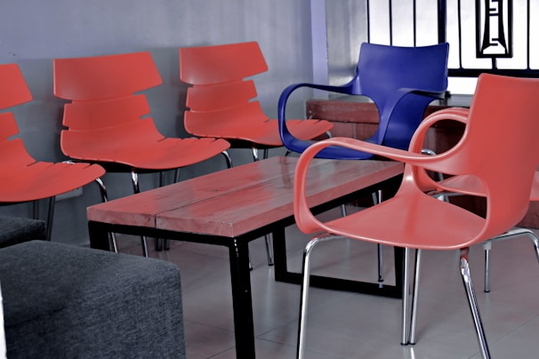 Upholstered visitor chairs arranged neatly around a glass meeting table, showcasing clean lines and comfortable design.