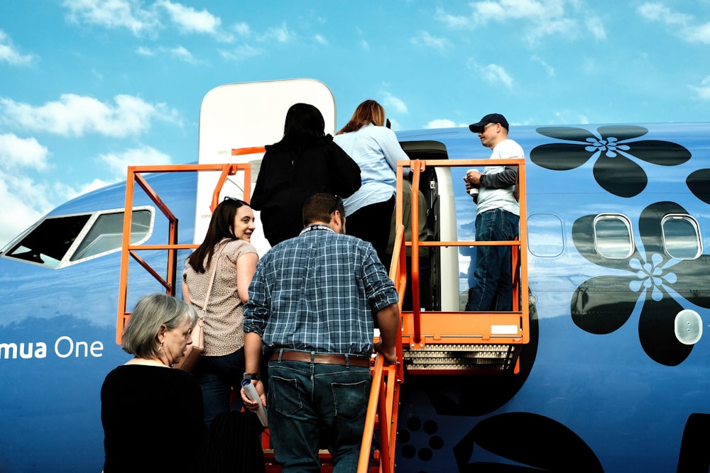 a group of people getting off of a plane