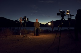 Atmospheric wide shot of a film set at dusk with warm, natural lighting.