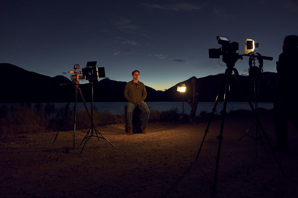 a man sitting on a chair in front of a camera