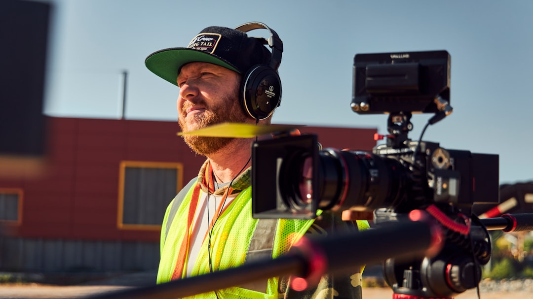 a man in a yellow vest and a green hat, One of our many projects with Woodlake Construction. Our team delivered high quality photo and video as well as some quality behind the scenes flicks!