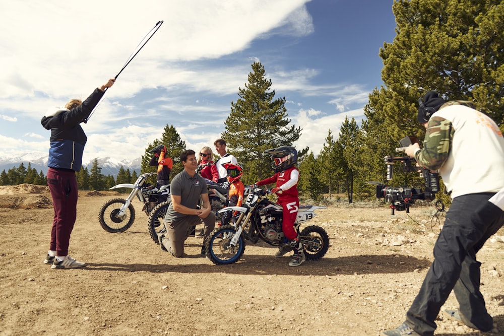 a group of people standing around a dirt bike
