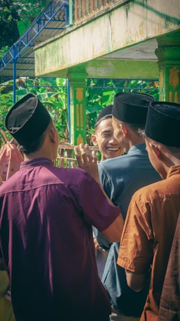 A small gathering scene with friends wearing lightweight traditional suits, radiating comfort and ease.