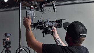 Close-up of a camera operator adjusting equipment during a live shoot.