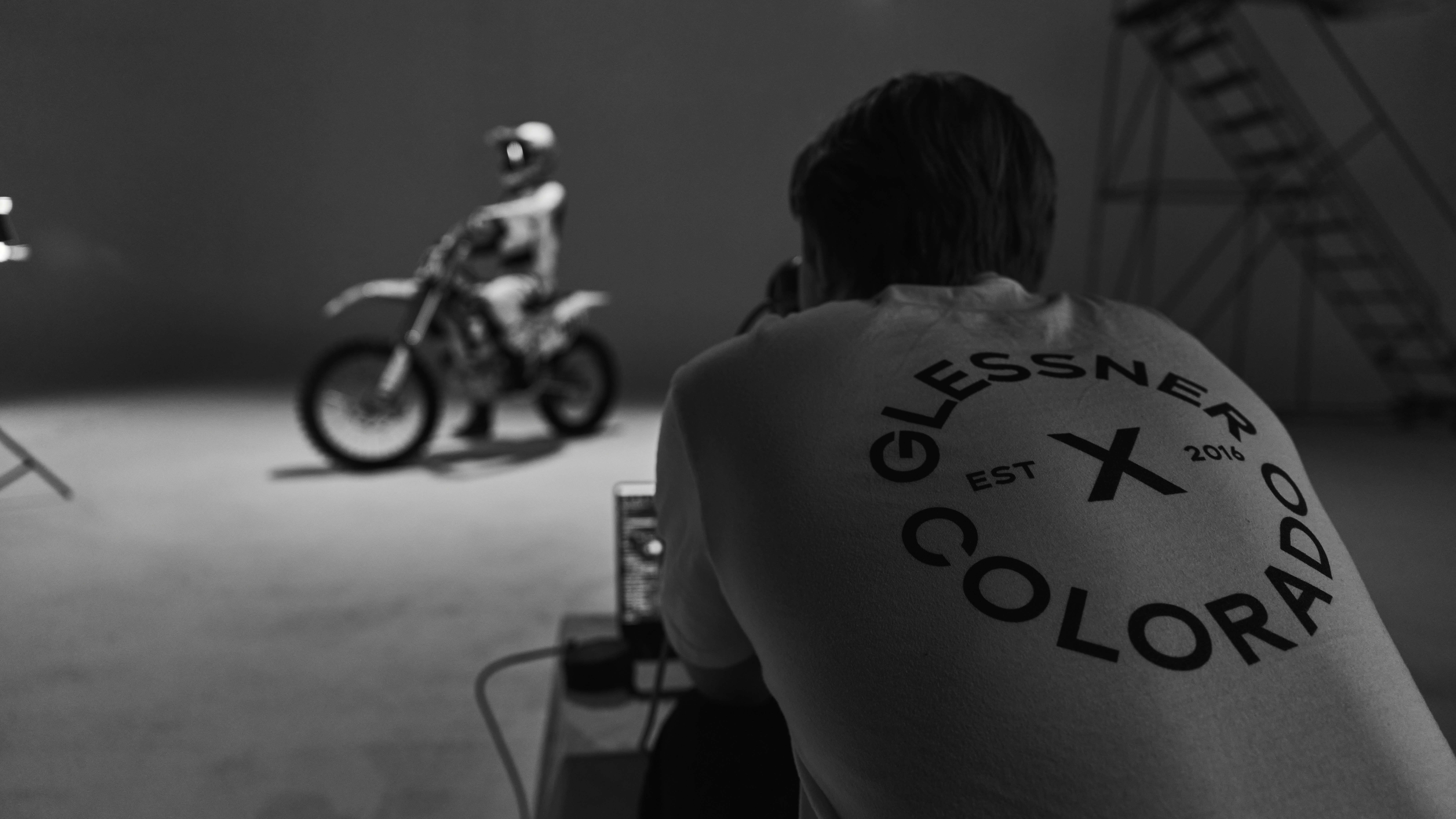 a man on a motorcycle is taking a picture of another man on a motorcycle