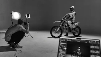 a black and white photo of a person on a motorcycle