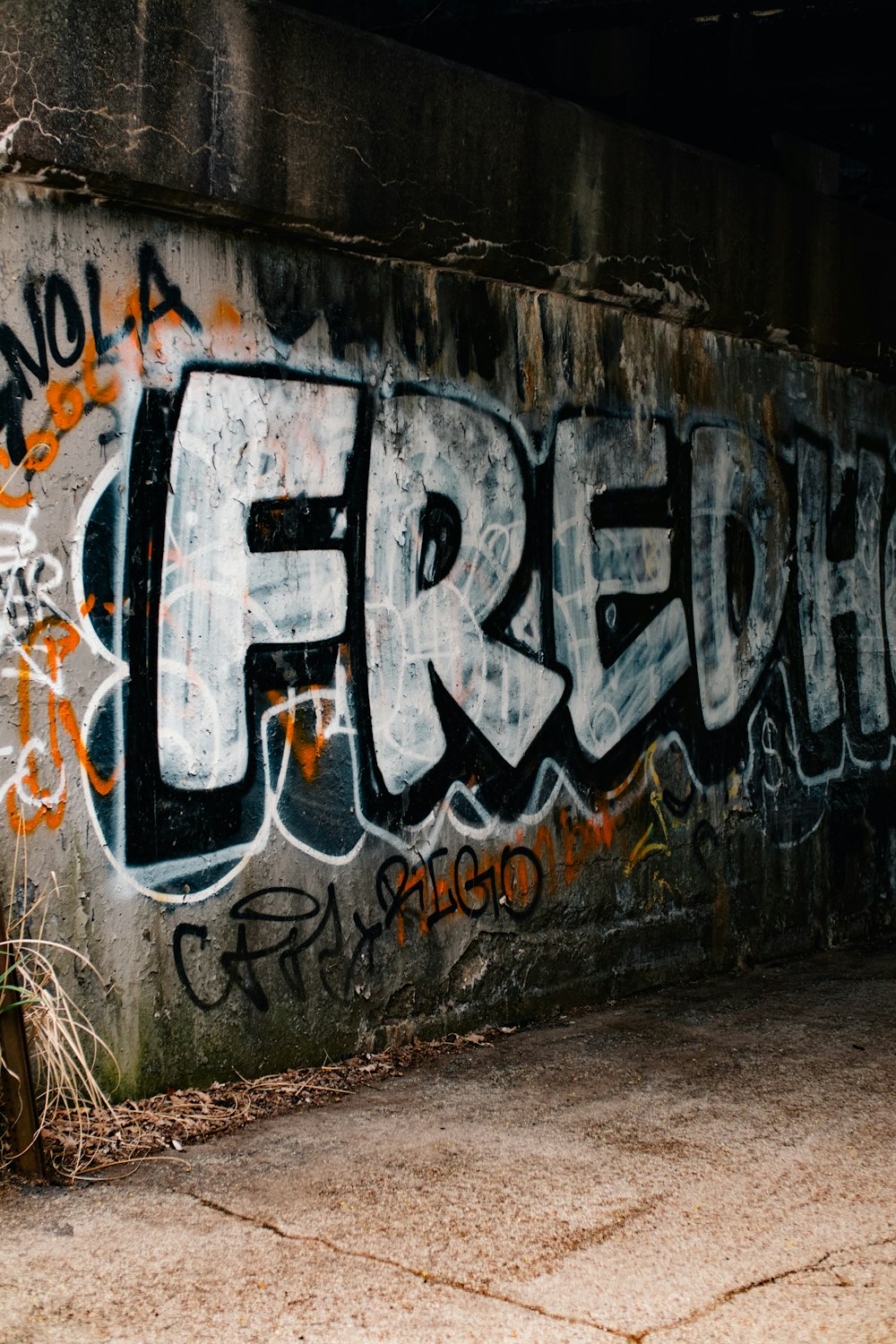 a wall covered in grafitti and graffiti