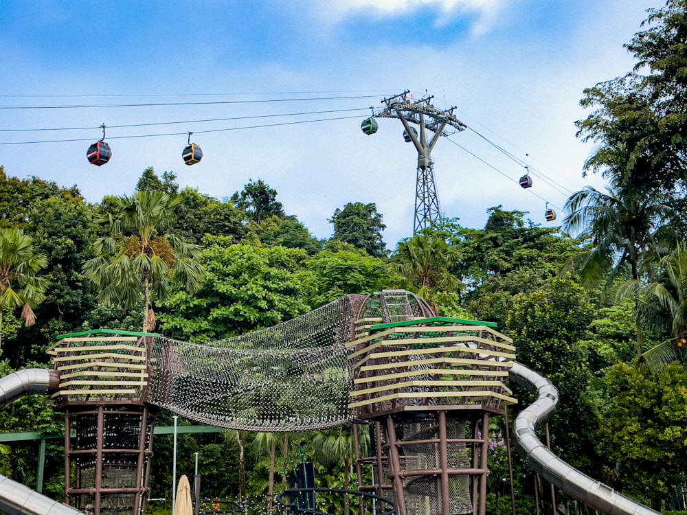 a couple of wooden structures sitting on top of a lush green hillside