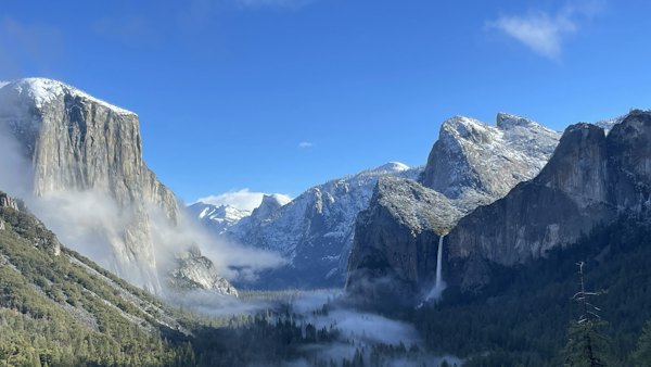 A view of a valley with a waterfall in the middle of it — Yosemite, United States