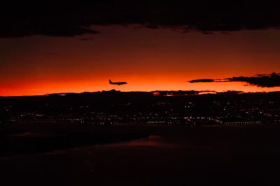 A sleek airplane ticket with a backdrop of Algiers cityscape at sunset.