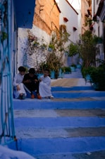 a couple of people sitting on some steps