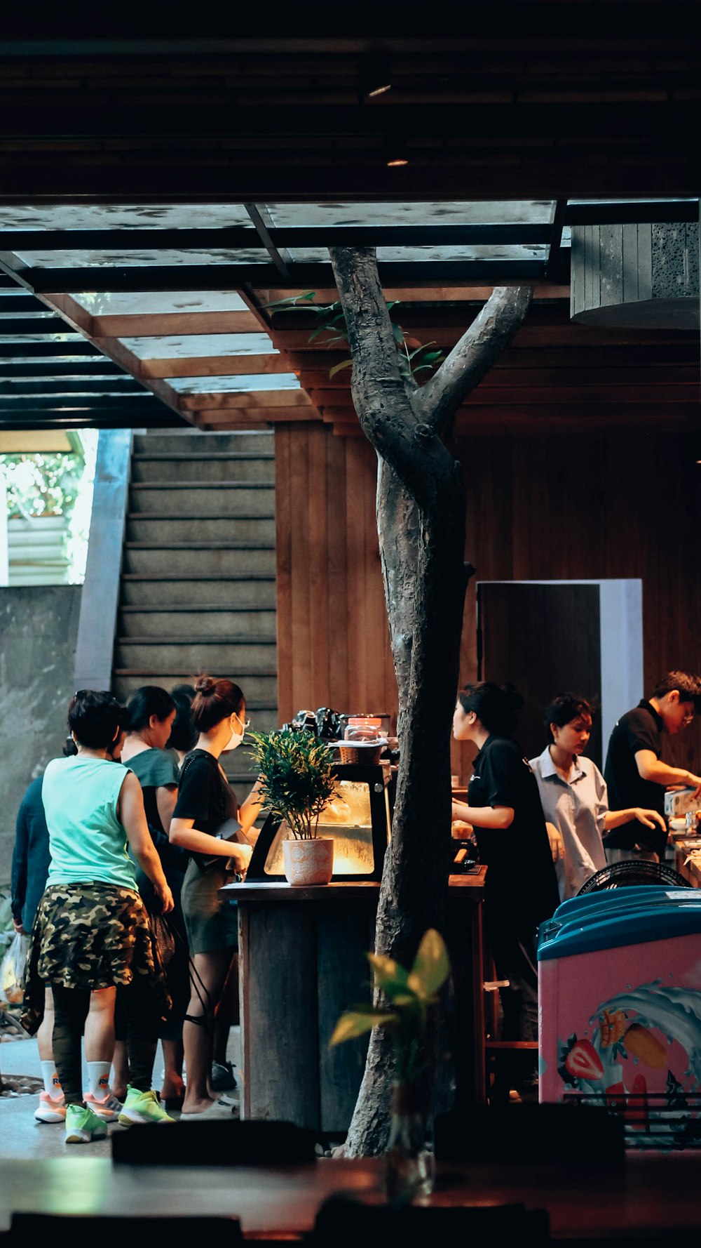 a group of people standing around a table