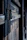 Close-up of tempered glass door hinges showing sturdy hardware and smooth finish.