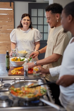 a group of people preparing food in a kitchen