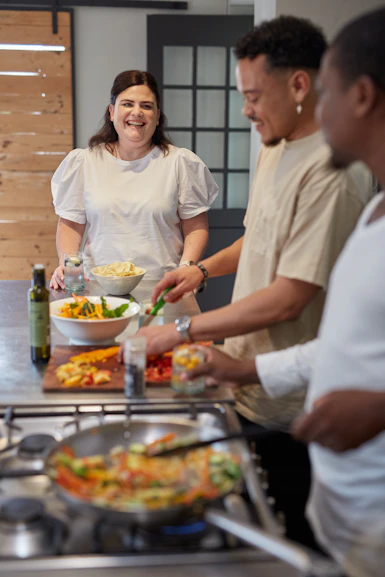 a group of people preparing food in a kitchen