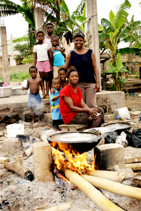 A group of families smiling together during a community workshop outdoors
