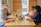 A cheerful group of friends enjoying a vegan meal together at a dining table.