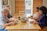 A warm gathering of diverse individuals sharing a meal together in a community kitchen.