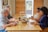 A cheerful group of friends enjoying a vegan meal together at a dining table.