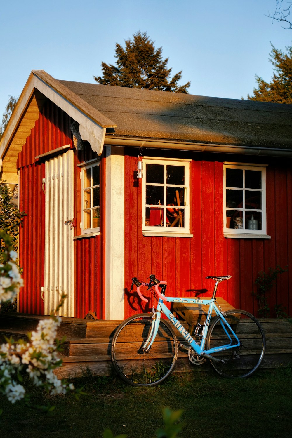 a bicycle parked in front of a red building
