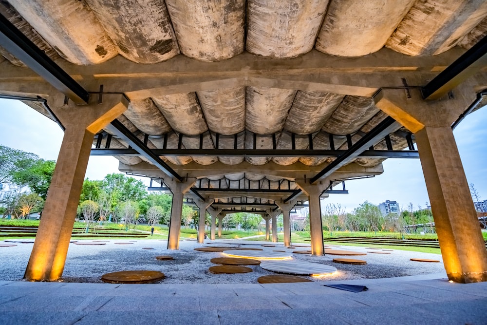 a covered walkway in a park with benches