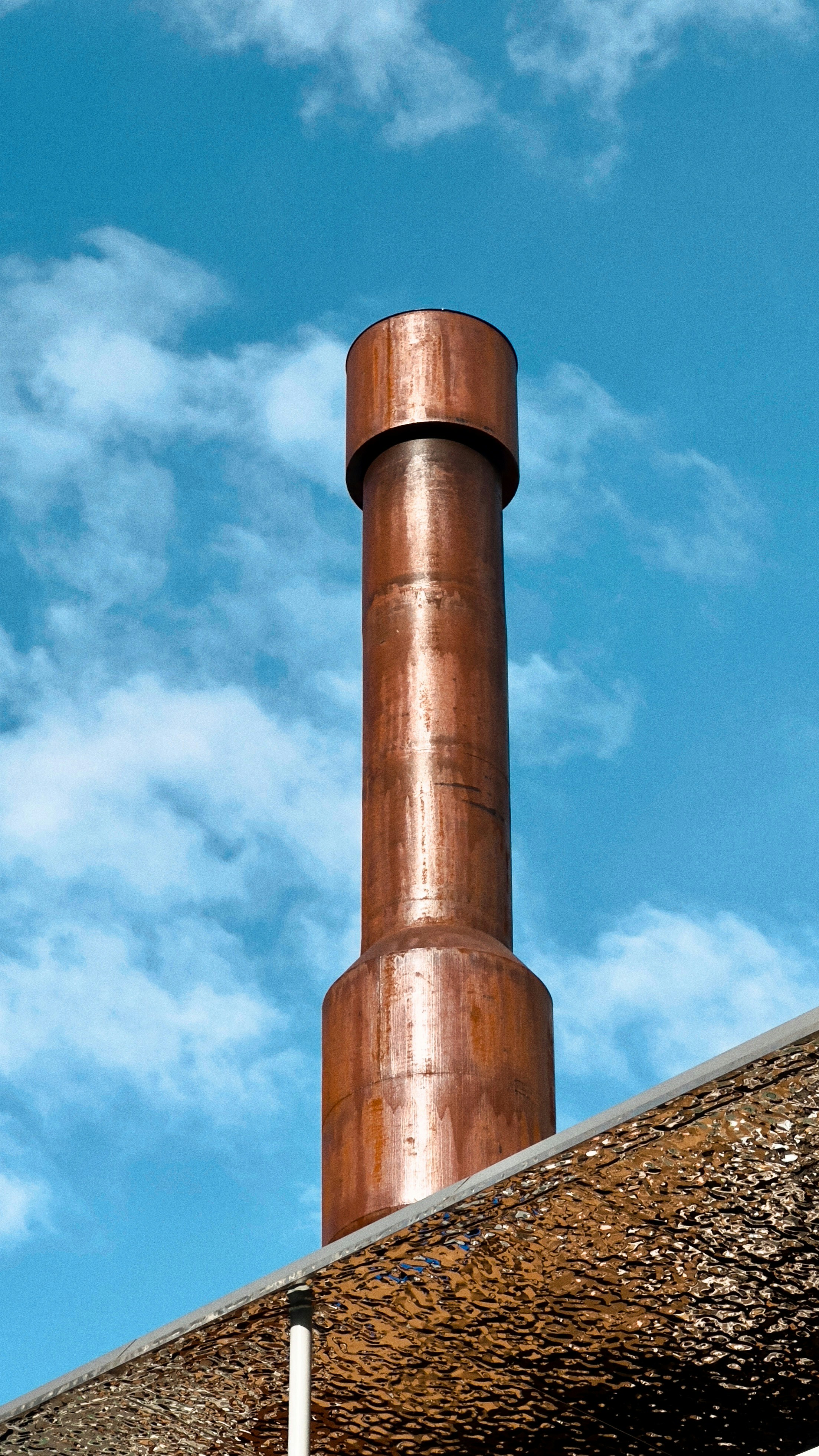 a tall metal chimney on top of a building