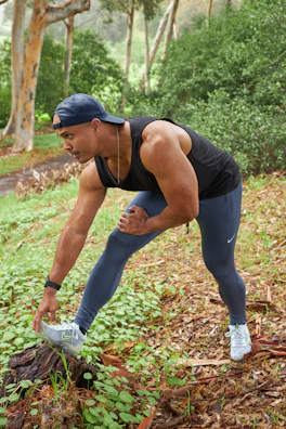 Close-up of a person wearing a posture-supporting intelligent threads shirt while stretching outdoors.