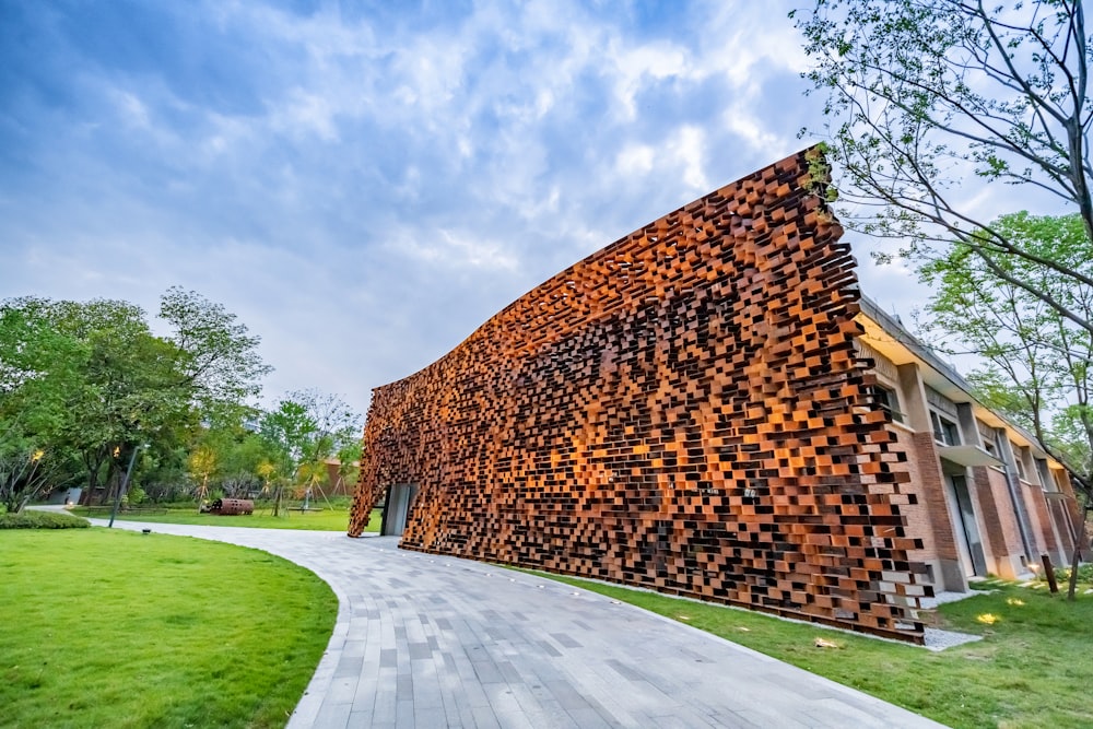 a large stack of logs sitting on top of a lush green field