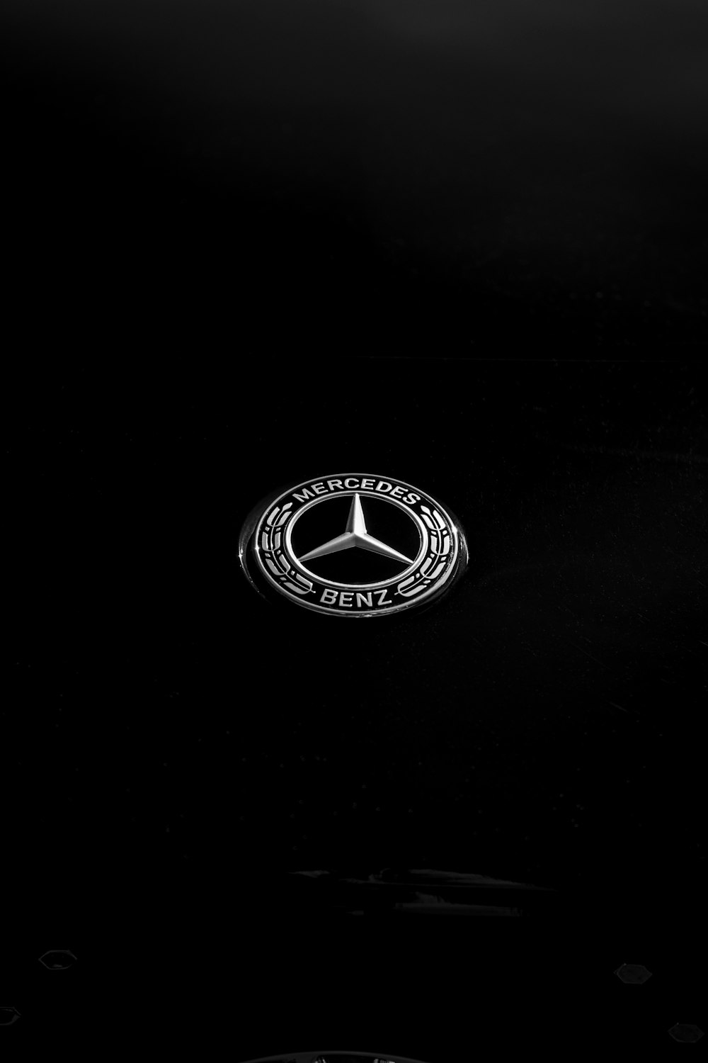 Ein Mercedes-Emblem ist im Dunkeln zu sehen