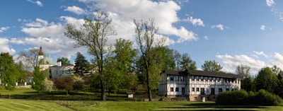 a large building sitting on top of a lush green field