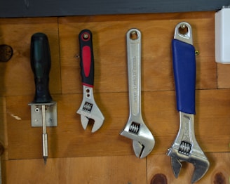 a bunch of tools are hanging on a wall