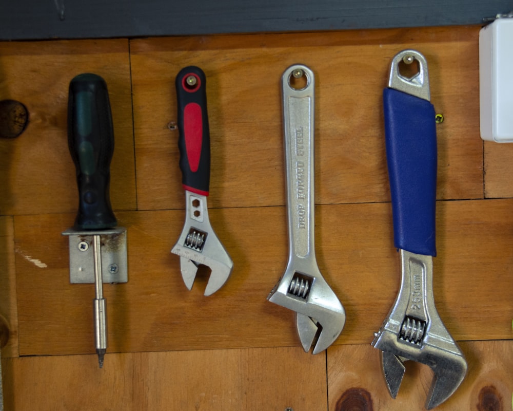 a bunch of tools are hanging on a wall